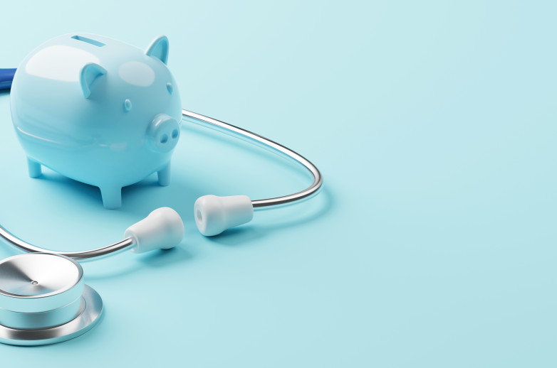 A small Piggy Bank is surrounded by a clinician's stethoscope.